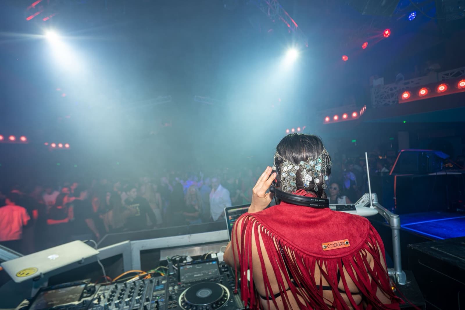 DJ booth facing a full nightclub floor