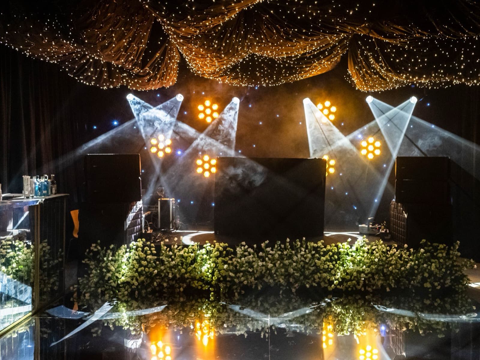 Stage set with spotlights and florals